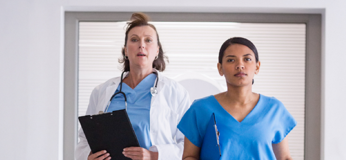 Medical staff walking speedily through corridor